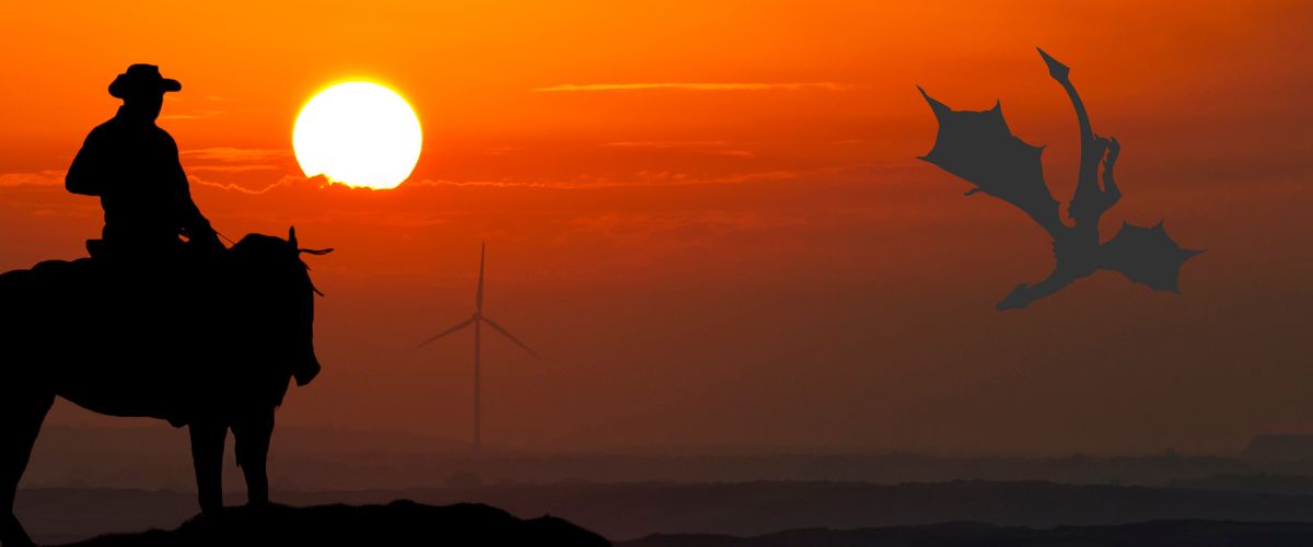 bright orange and red sunset with silhouette of a cowboy in the foreground and a flying dragon silhouette in the background